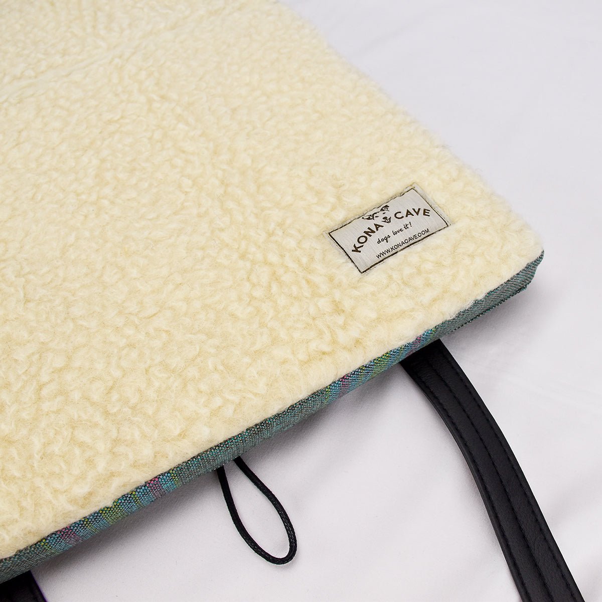 Luxury KONA CAVE® Folded Travel Dog Bed for restaurants, cars, pubs and hotels.  Pastel plaid portable dog bed open to show 100% Natural Sheep Wool Lining