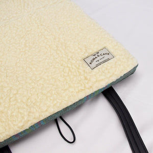 Luxury KONA CAVE® Folded Travel Dog Bed for restaurants, cars, pubs and hotels.  Pastel plaid portable dog bed open to show 100% Natural Sheep Wool Lining