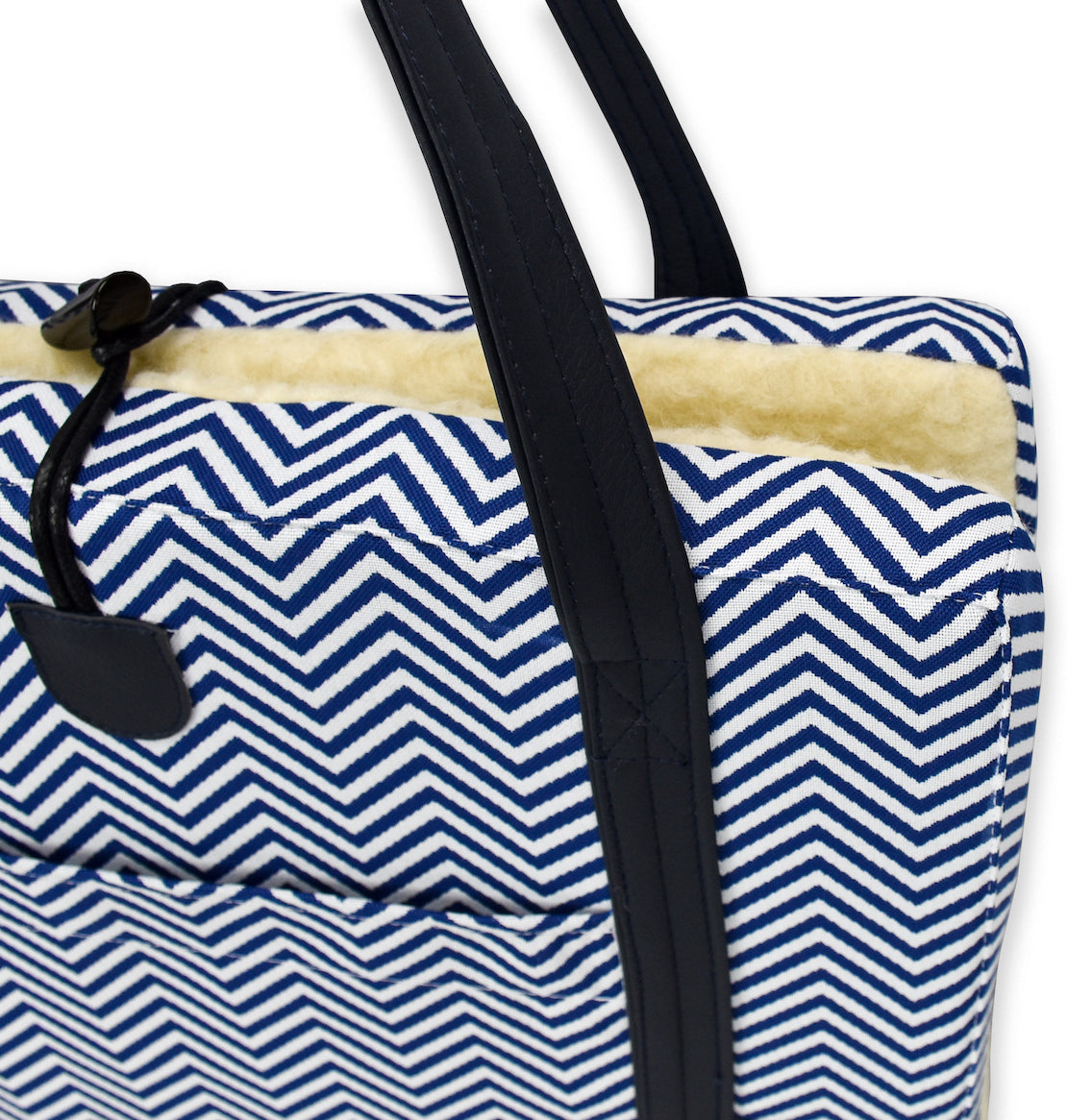 Close up of the Premium Chevron exterior upholstry fabric on the KONA CAVE® Travel Dog Bed in navy blue and white