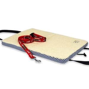 Dog Travel Mat open with wooly lining and red collar and lead on a white background