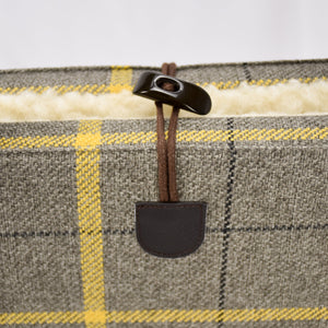 Detail of the brown single handed toggle fastening on the top of the KONA CAVE® Travel Dog Bed with sheep-friendly real wool lining